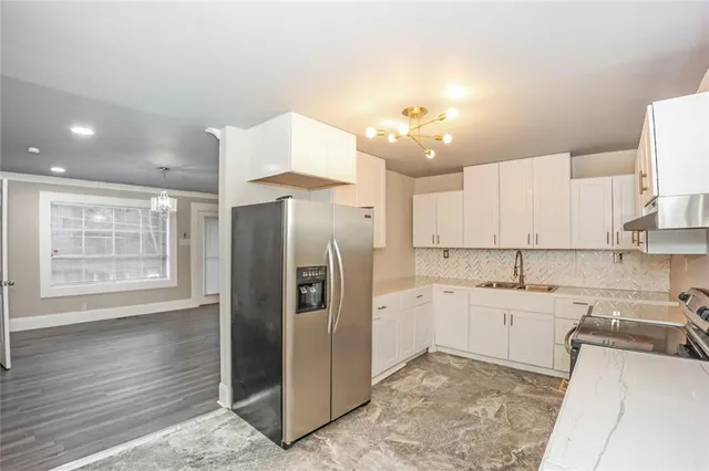 a kitchen with a sink stainless steel appliances and cabinets