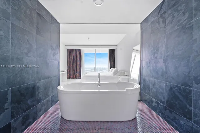 a white bath tub sitting in a bathroom