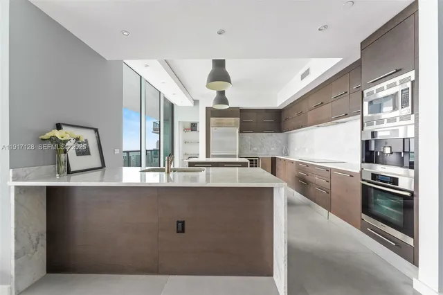 a kitchen with counter top space and stainless steel appliances