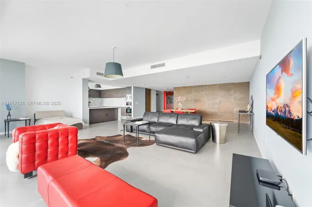 a living room with fireplace furniture and a flat screen tv