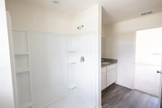 an empty room with a window and closet