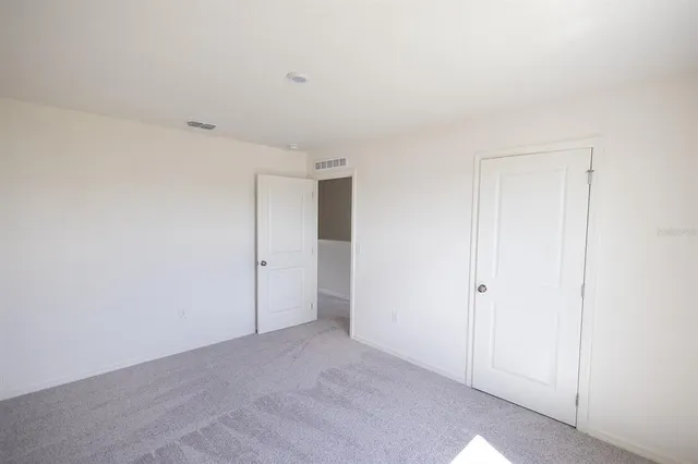 a bathroom with a granite countertop toilet a sink and shower