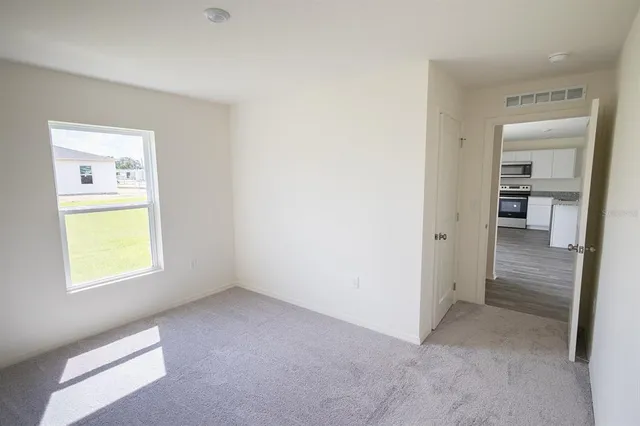 a kitchen with a sink cabinets and wooden floor