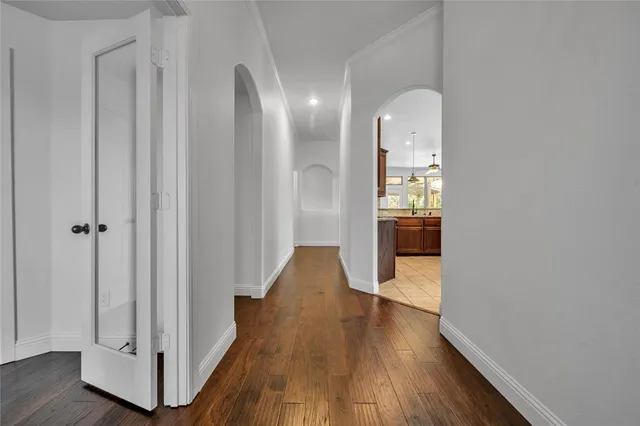 a view of a hallway with wooden floor and staircase