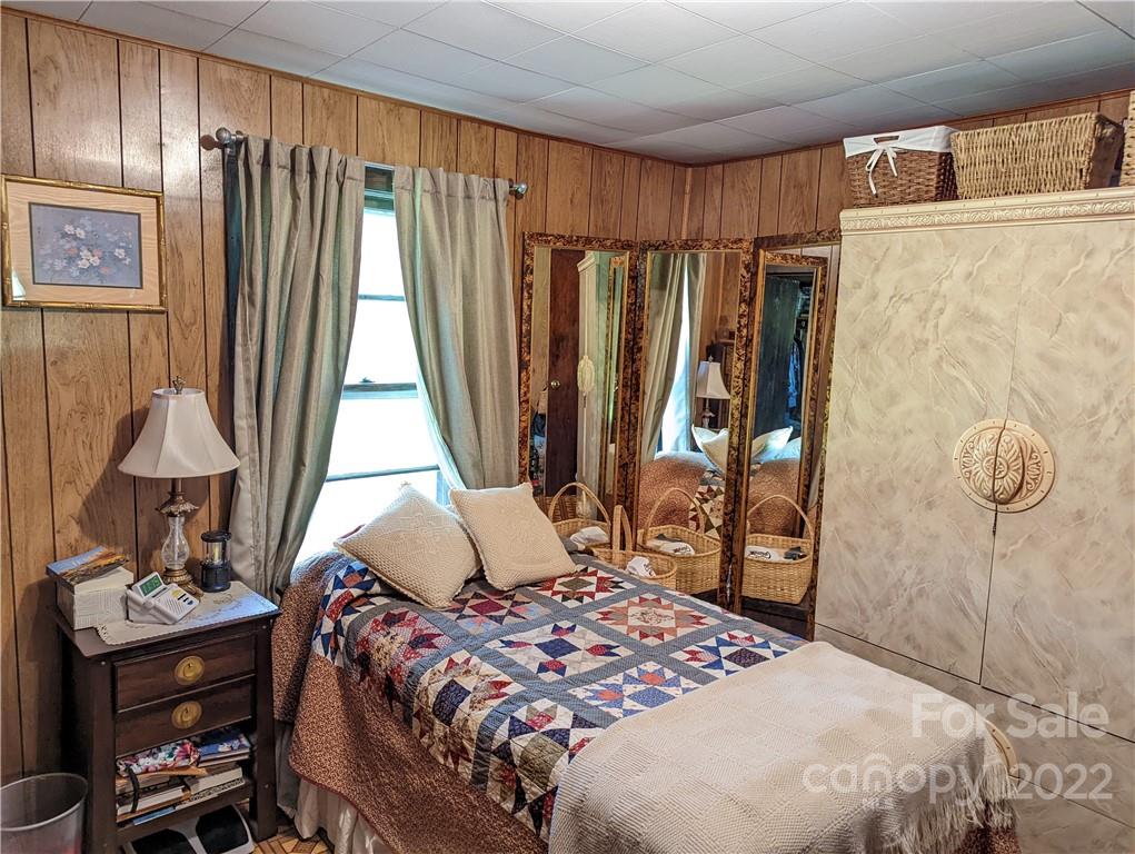 241 Lynch Road Mill Spring, NC 28756 - Photo 34 of 35 a bedroom with a bed and a table