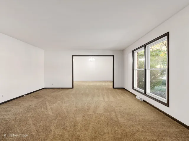 an empty room with large window