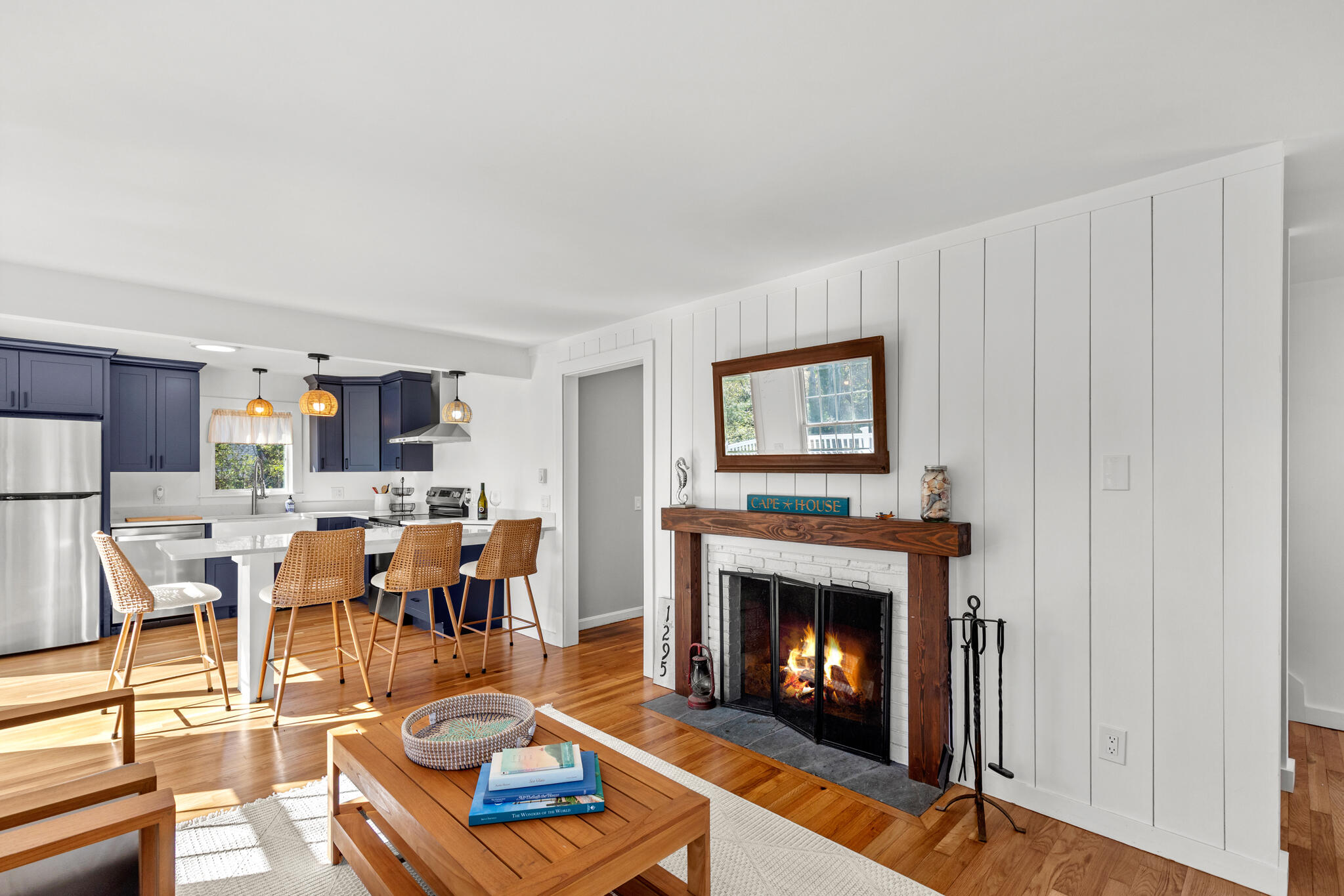 1295 Massasoit Road Eastham, MA 02642 - Photo 9 of 32 a living room with furniture a window and a fireplace