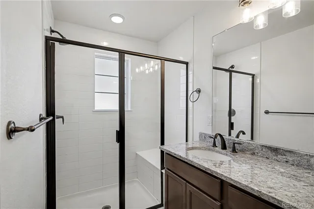 a bathroom with a granite countertop sink mirror and double