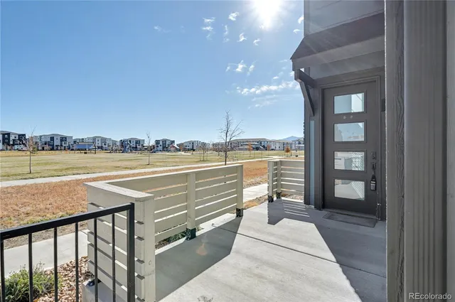 a view of a balcony with wooden floor and seating space