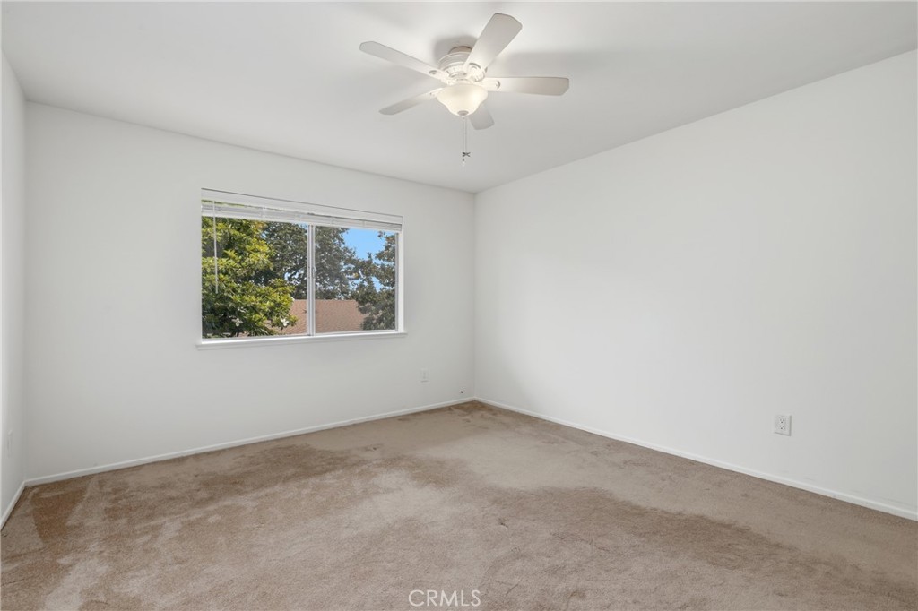 12200 Montecito Road, Unit D301 Seal Beach, CA 90740 - Photo 12 of 28 an empty room with windows and ceiling fan