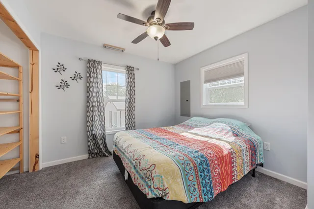 a bedroom with a bed and a window