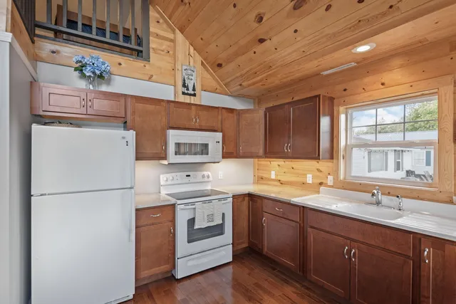 a kitchen with a sink a refrigerator and window