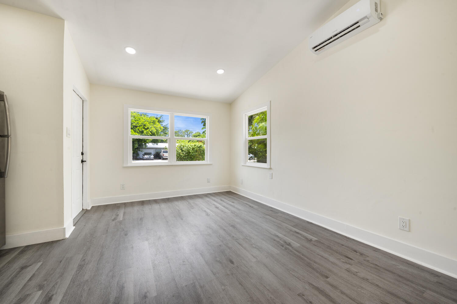 5331 Southeast Ebbtide Avenue Stuart, FL 34997 - Photo 11 of 24 an empty room with wooden floor and window