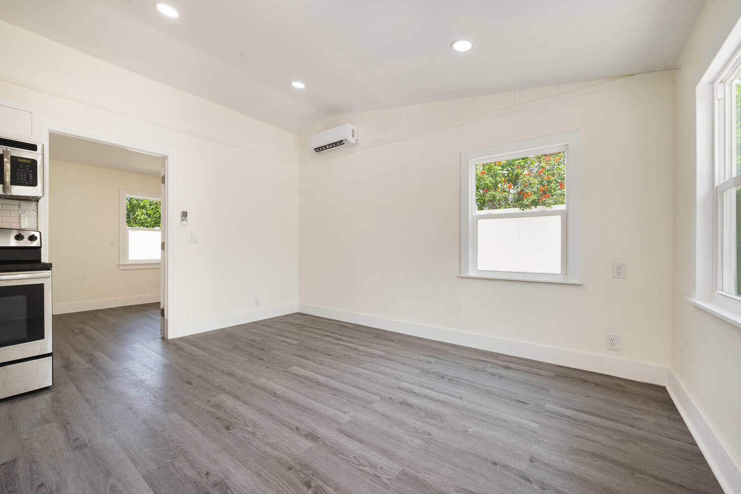 5331 Southeast Ebbtide Avenue Stuart, FL 34997 - Photo 12 of 24 an empty room with wooden floor and a window