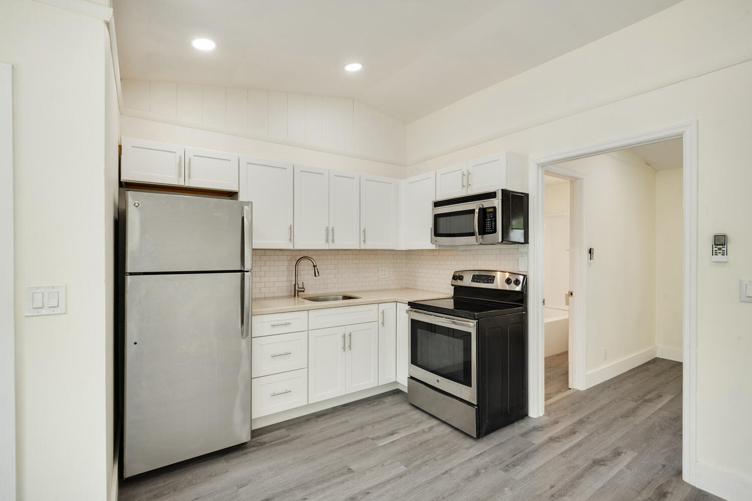 5331 Southeast Ebbtide Avenue Stuart, FL 34997 - Photo 15 of 24 a kitchen with cabinets stainless steel appliances and wooden floor