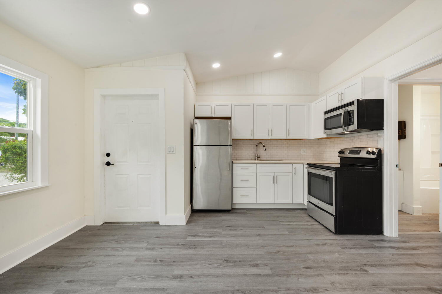 5331 Southeast Ebbtide Avenue Stuart, FL 34997 - Photo 16 of 24 a kitchen with a refrigerator stove and wooden floor