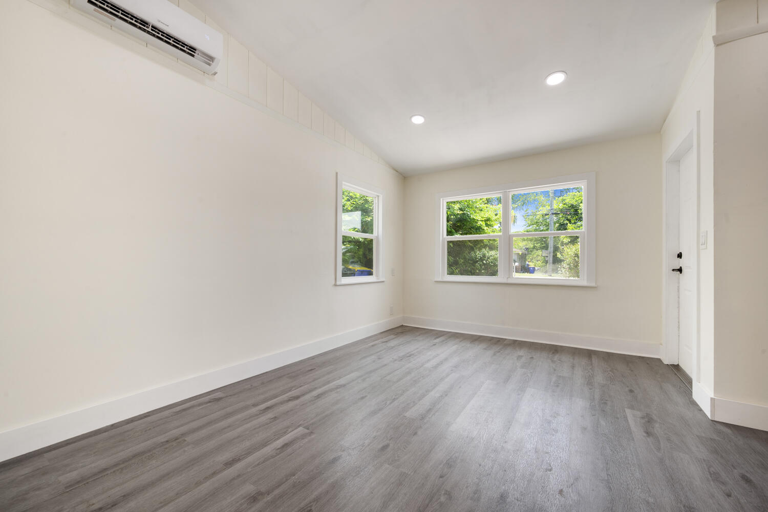 5331 Southeast Ebbtide Avenue Stuart, FL 34997 - Photo 21 of 24 an empty room with wooden floor and windows