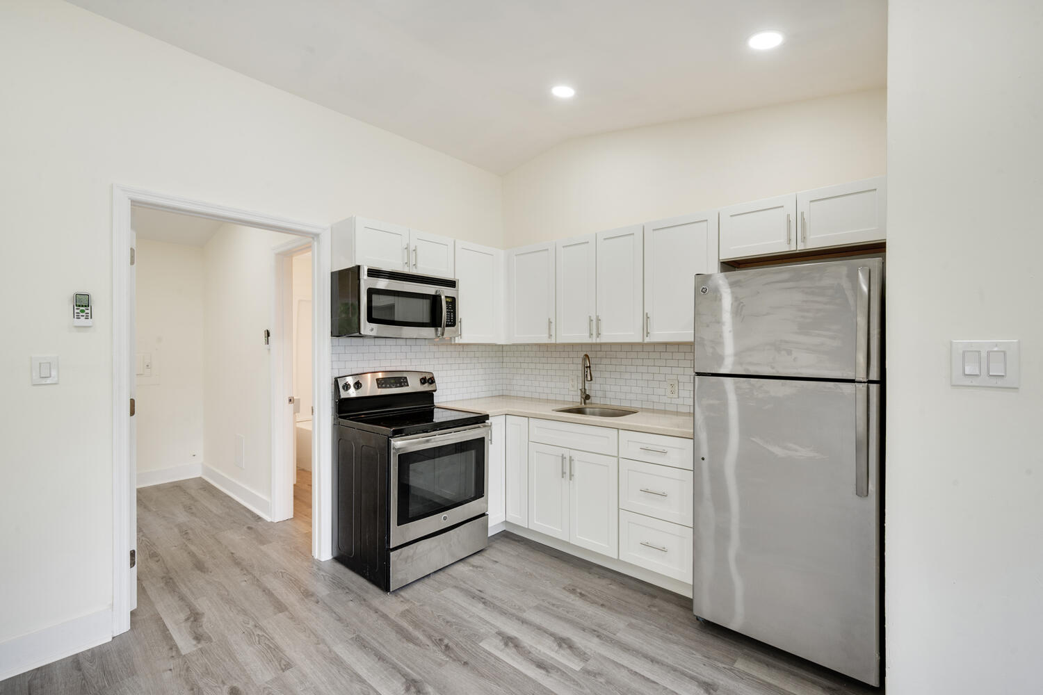 5331 Southeast Ebbtide Avenue Stuart, FL 34997 - Photo 6 of 24 a kitchen with white cabinets and stainless steel appliances