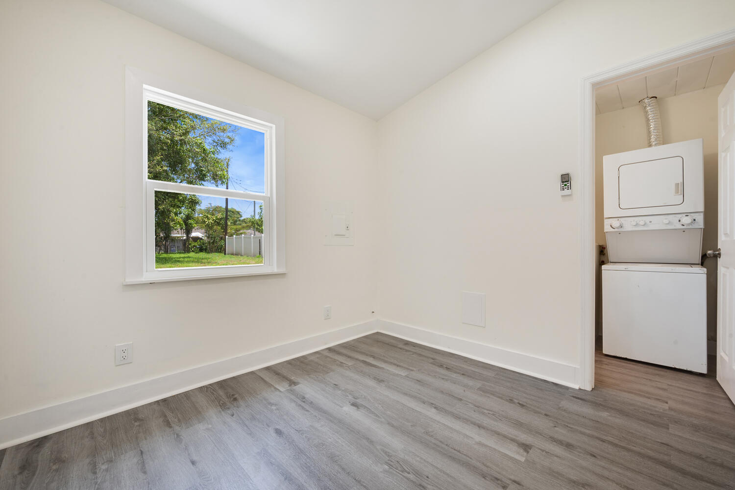 5331 Southeast Ebbtide Avenue Stuart, FL 34997 - Photo 9 of 24 a view of a kitchen with wooden floor and windows