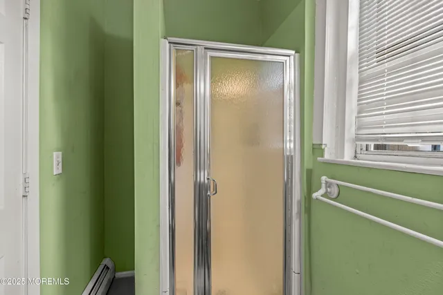 a bathroom with a shower and a sink