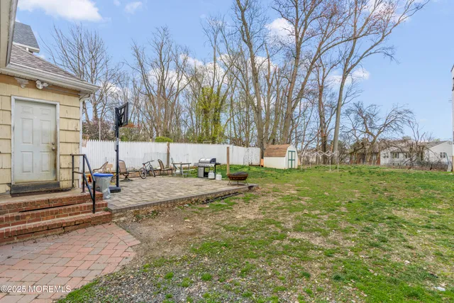 a view of a yard with wooden fence