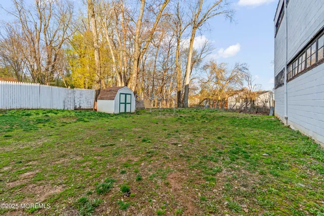 a view of a yard with large trees