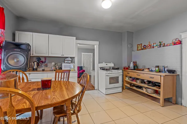 a kitchen with stainless steel appliances a stove a sink cabinets and a refrigerator