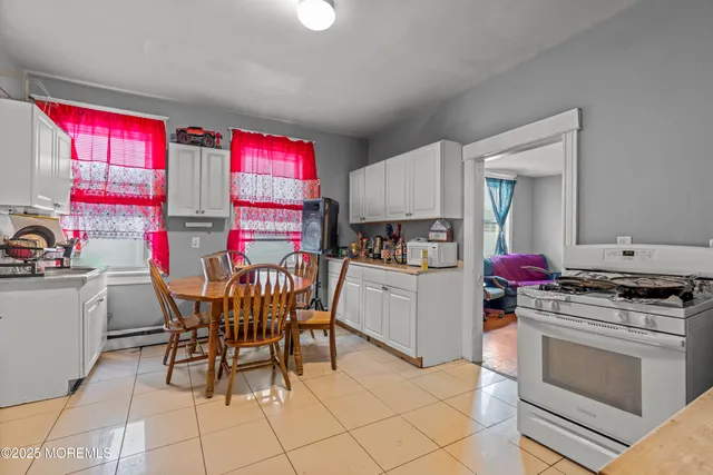 a kitchen that has a dining table and chairs in it