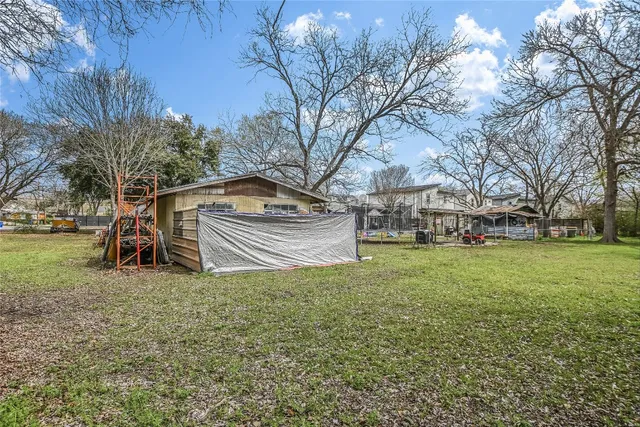 a view of an house with backyard space and balcony