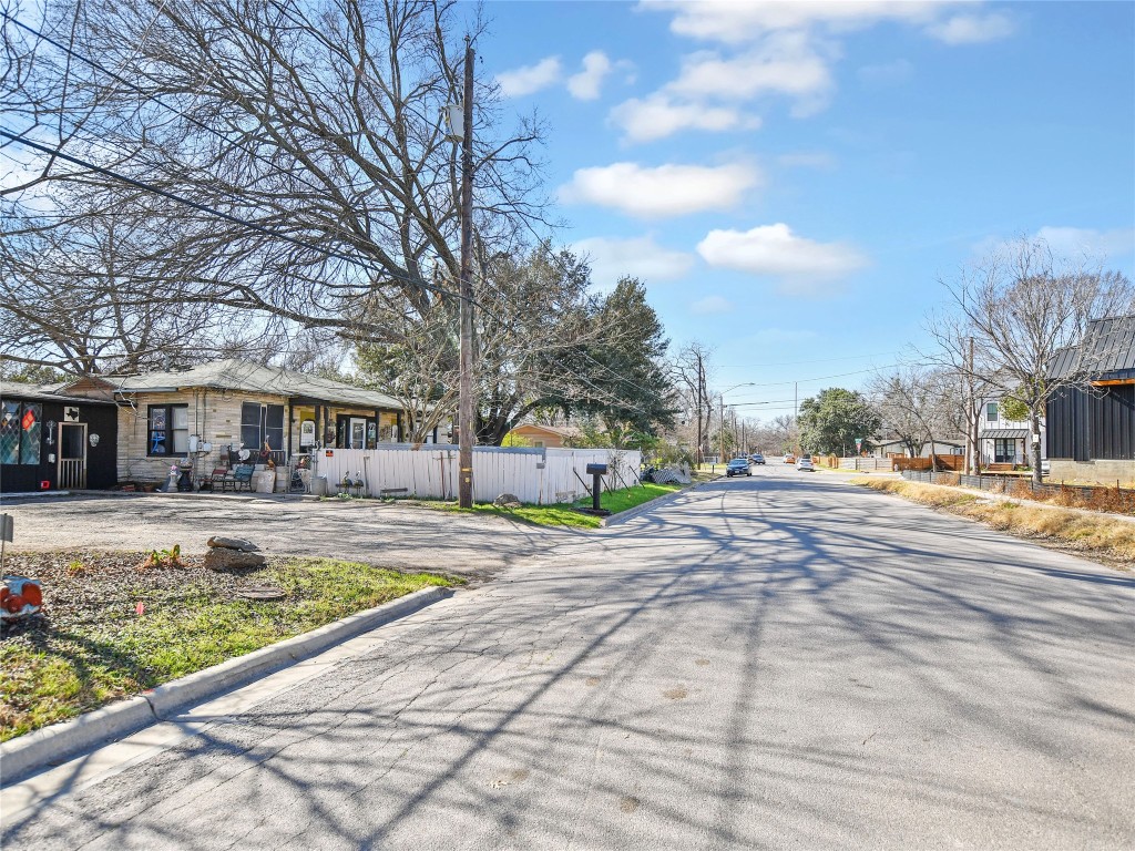 5405 Prock Lane Austin, TX 78721 - Photo 3 of 13 a view of a white house with a large trees and yard