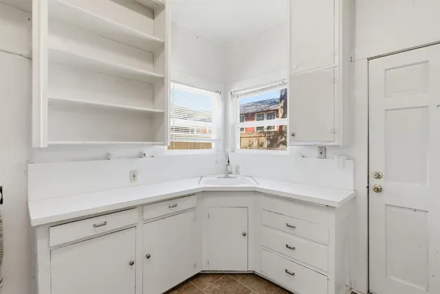 a view of kitchen appliances and cabinets