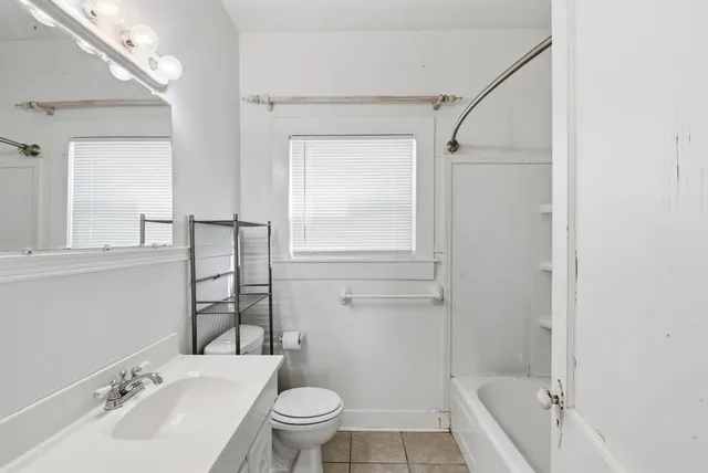a bathroom with a shower and toilet