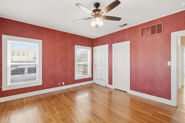a view of empty room with wooden floor