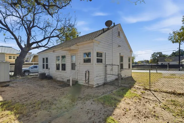 a outdoor view of a house with a tree