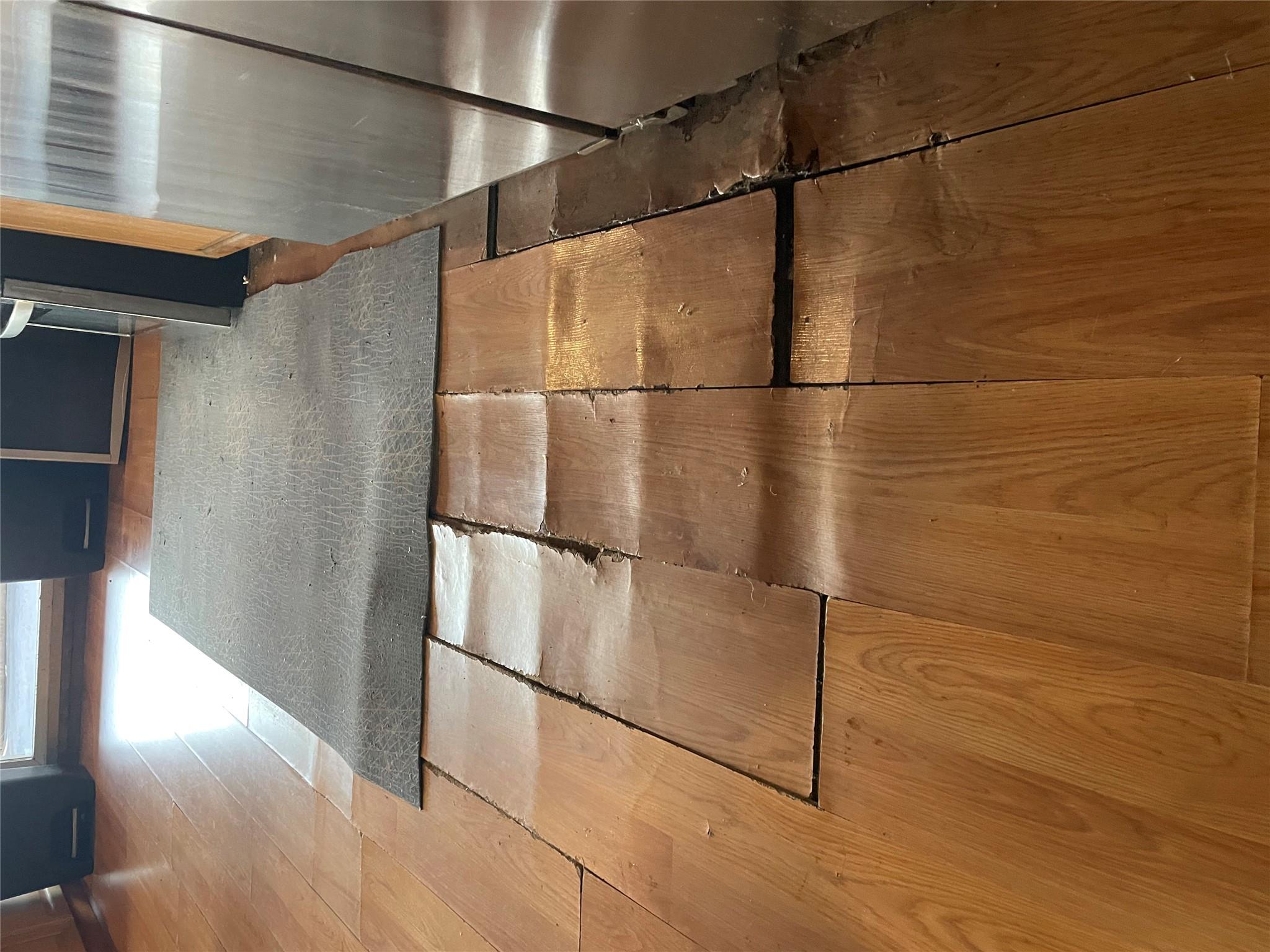 234 Betts Avenue Bronx, NY 10473 - Photo 4 of 11 a view of an empty room with wooden floor