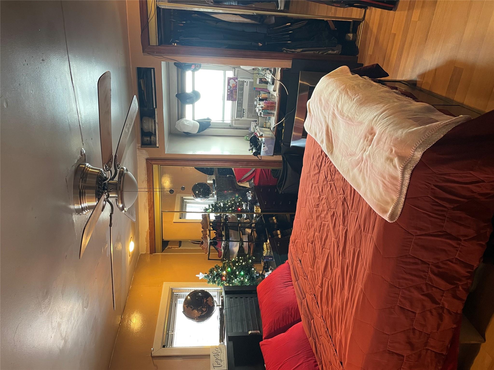 234 Betts Avenue Bronx, NY 10473 - Photo 5 of 11 a bedroom with a large bed and a large mirror with a flat tv screen