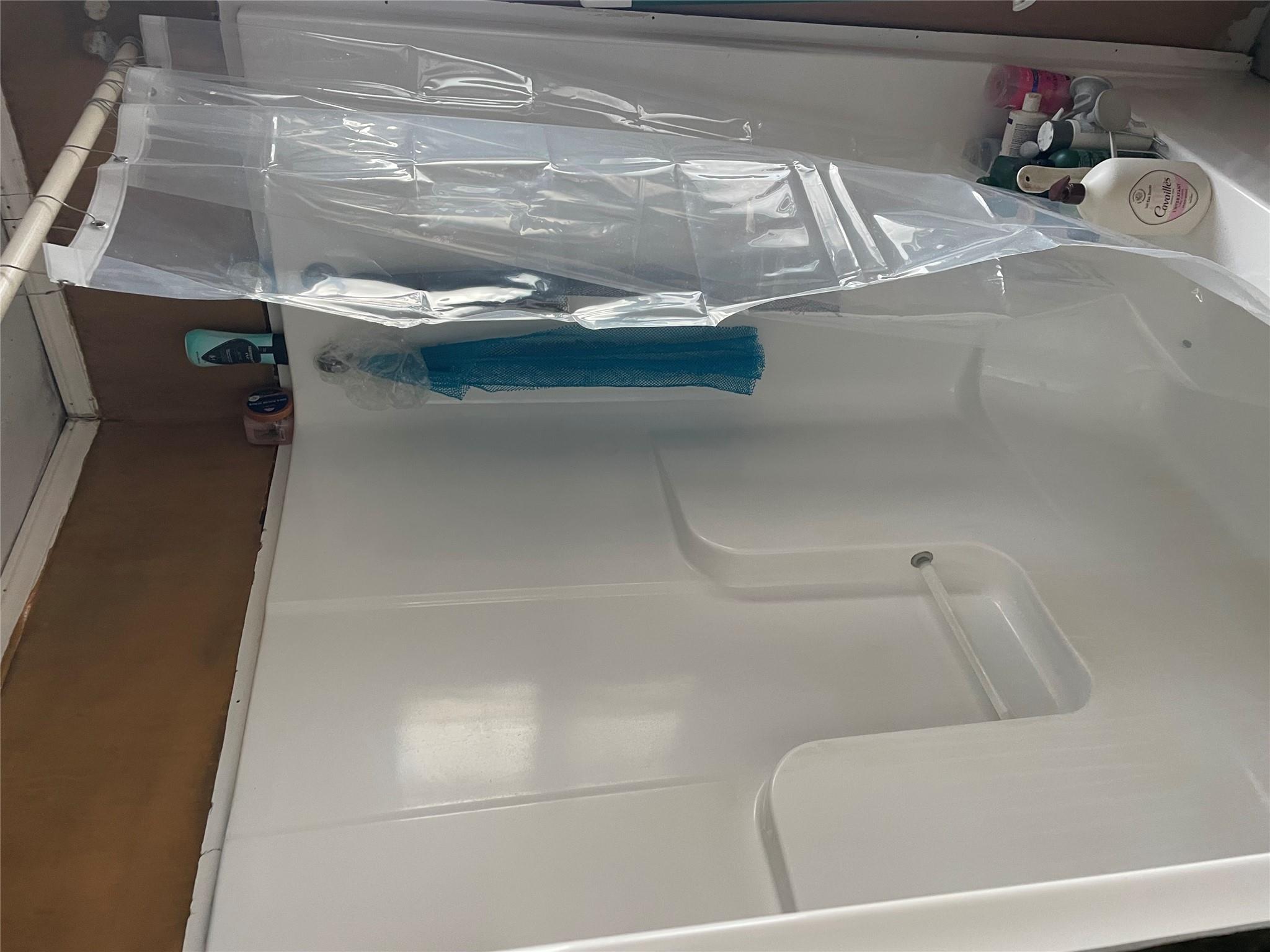 234 Betts Avenue Bronx, NY 10473 - Photo 6 of 11 a bathroom with a glass shower door