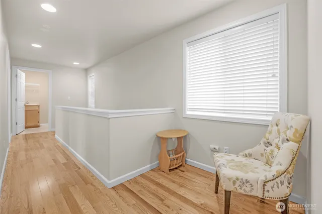 a workspace with a desk chair and painting on the wall