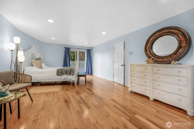 a bedroom with a bed dresser and a window