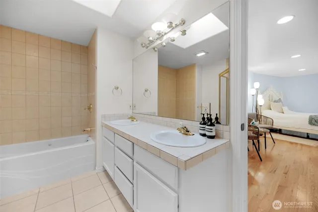 a bathroom with a glass shower door and a shower