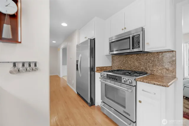 a living room with furniture fireplace and wooden floor
