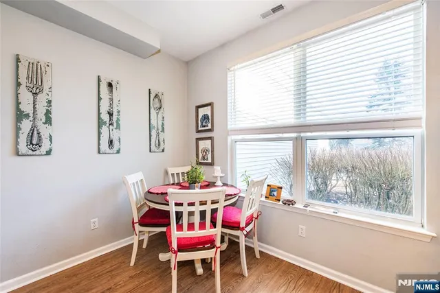 a dining room with furniture a rug and wooden floor
