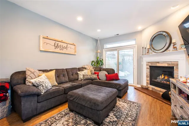 a living room with furniture a large window and a fireplace