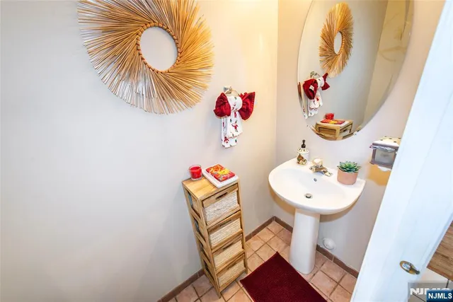 a bathroom with a sink mirror and vanity