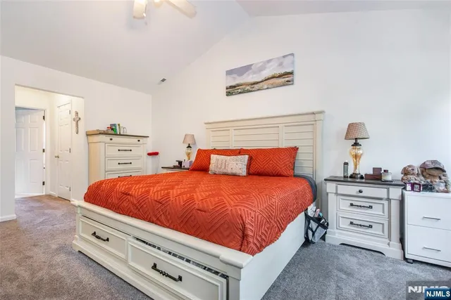 a bedroom with bed and dresser