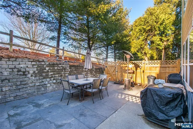 a view of a patio with table and chairs and potted plants