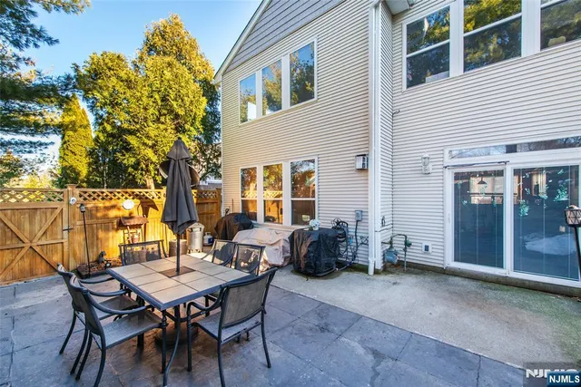 a backyard of a house with table and chairs