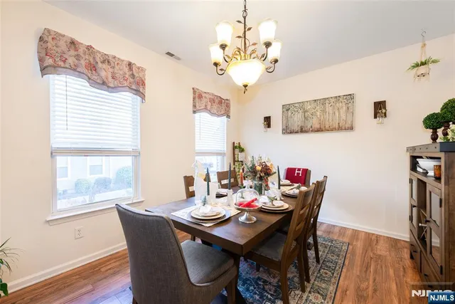 a dining room with wooden floor and breakfast area