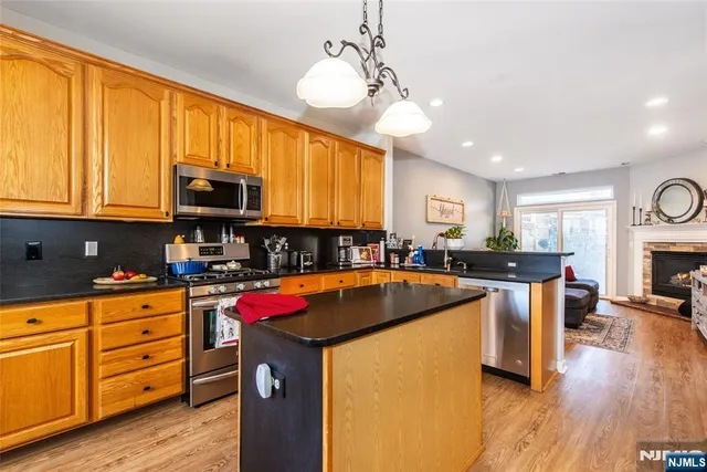 a kitchen with kitchen island granite countertop a sink cabinets and window