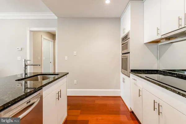 a kitchen with granite countertop a sink and a stove